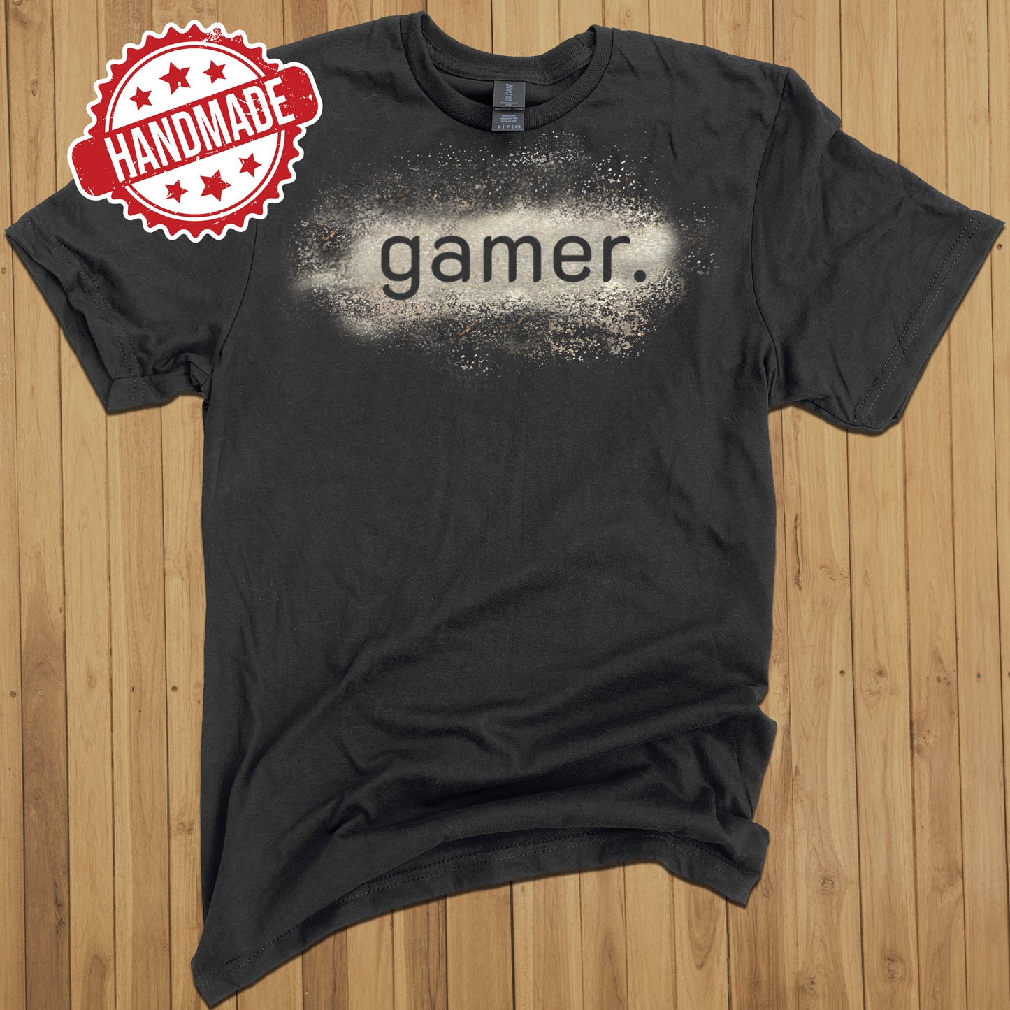 Black tee shirt with a design that says "gamer", which has been created with bleach