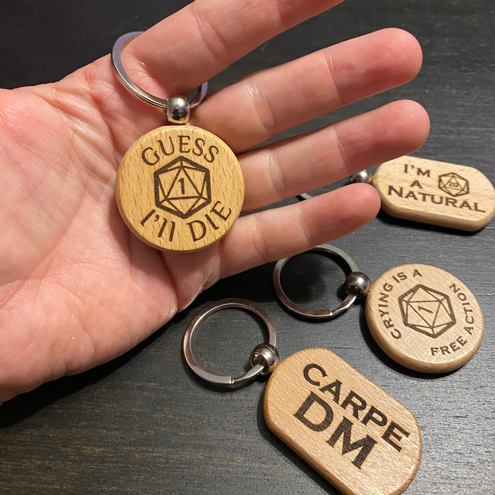 Several keychains with role playing designs on them: Carpe DM, D20, Crying is a free action, I'm a natural