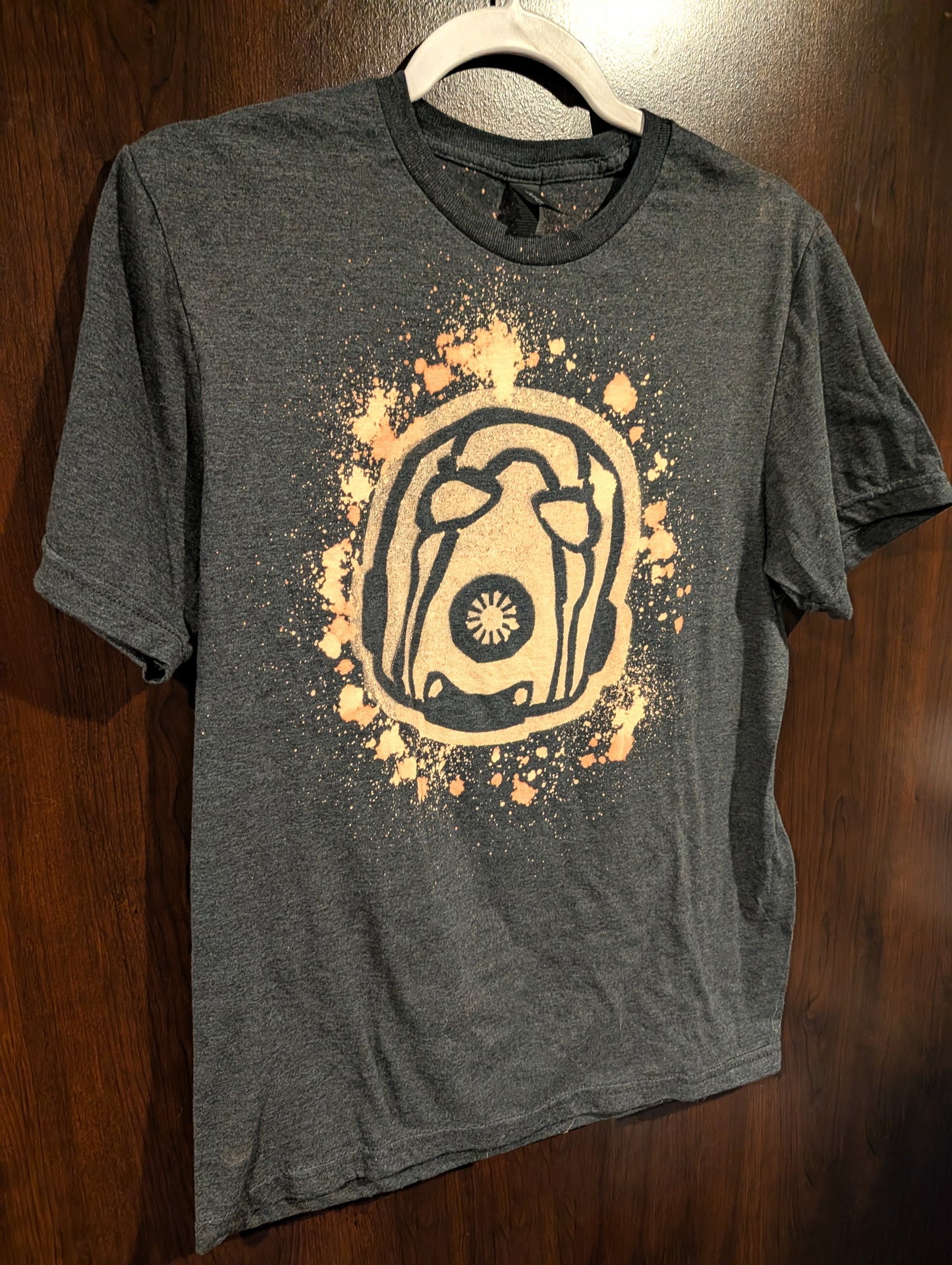 Charcoal shirt with a boderlands psycho design made out of bleach