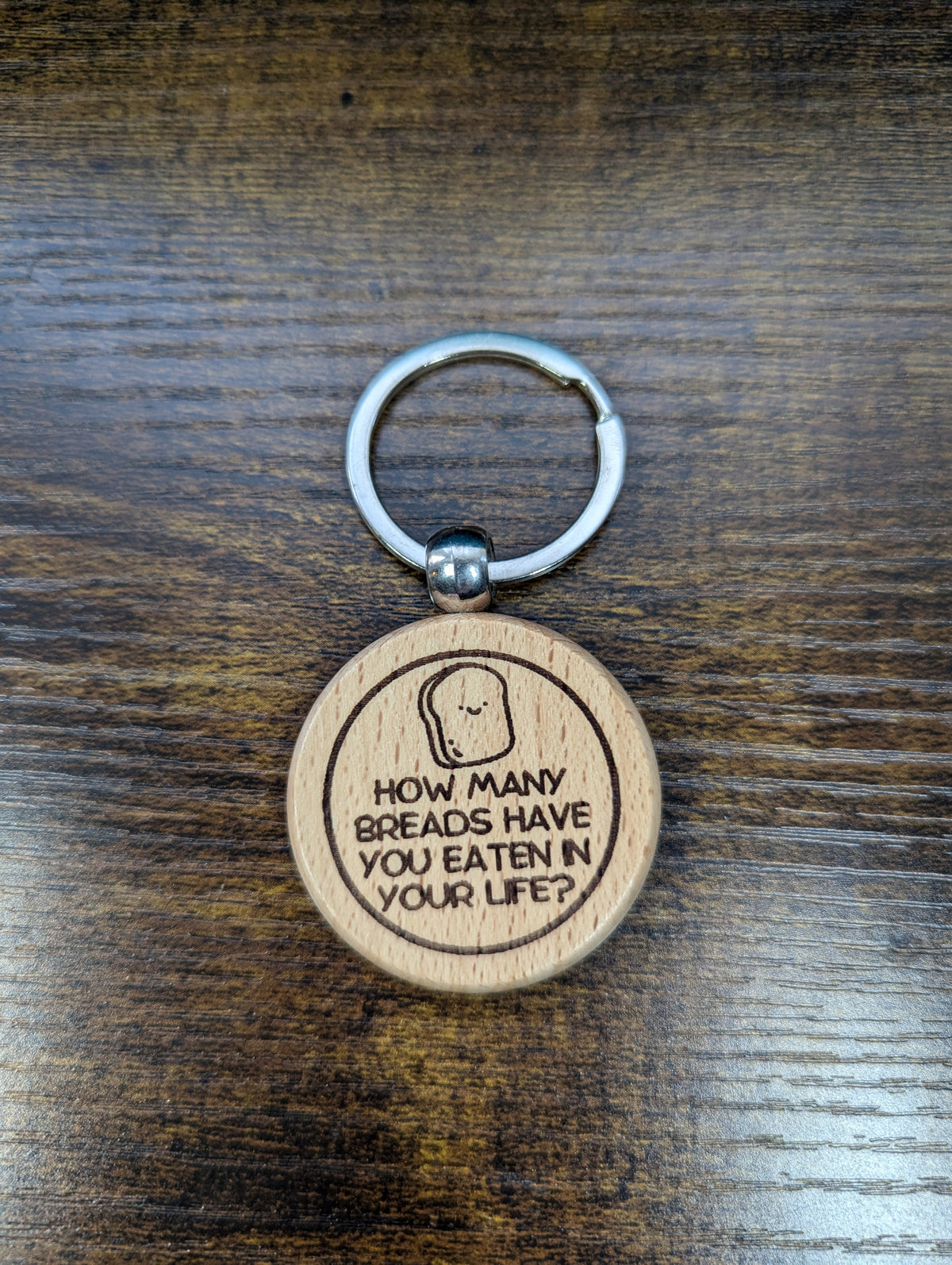 Round wooden anime keychain laser-engraved with "How many breads have you eaten in your life?" JoJo quote