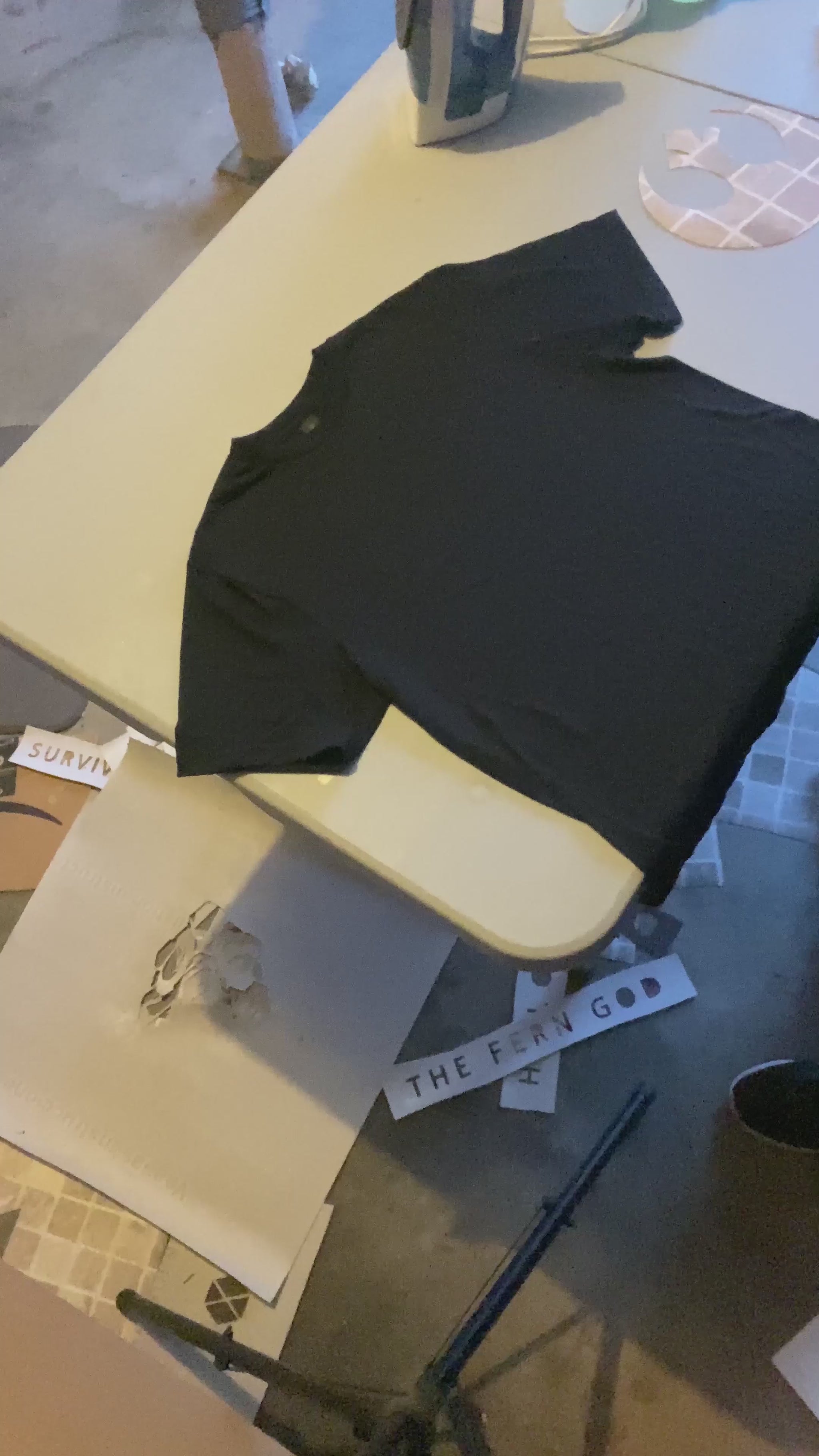 Process of using a Rebel Alliance stencil to create the design on a black tee shirt, using bleach to lighten the area around the logo.