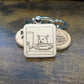 square wooden keychain with an engraved image of the Smudge the salad cat